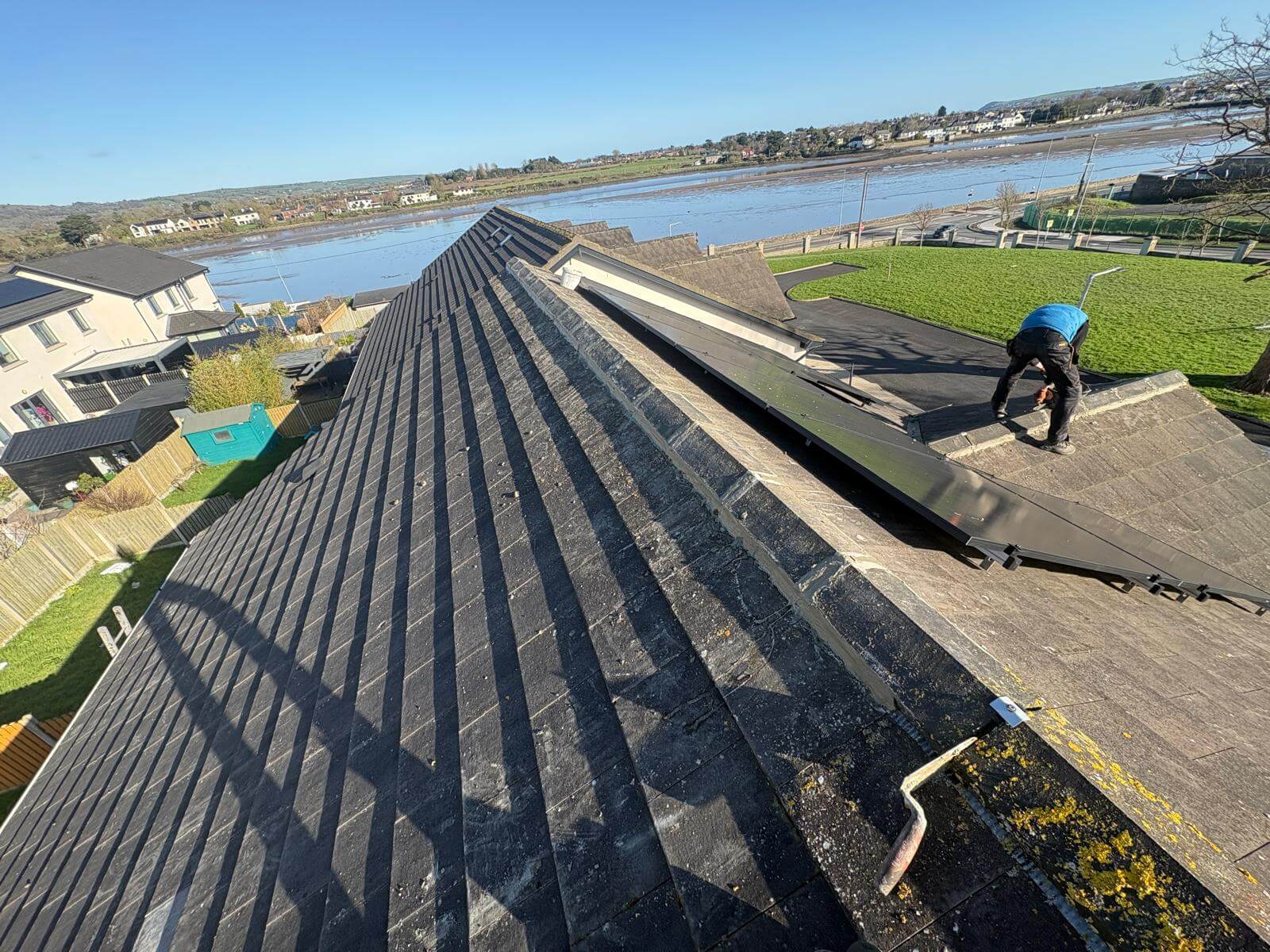 Roofers working on an old roof in Cork City